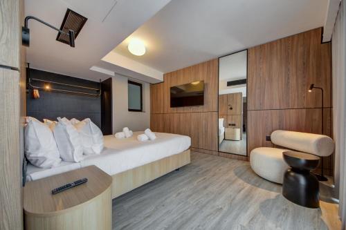 a hotel room with a bed and a desk at Noru Hotel Malta - Adults Only Hotel in St Julian's