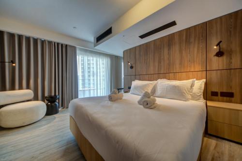a hotel room with a bed with two teddy bears on it at Noru Hotel Malta - Adults Only Hotel in St Julian's
