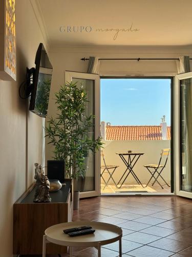 a living room with a view of a patio at Grupo Morgado - Quinta do Morgado - Morgado Privilege in Tavira