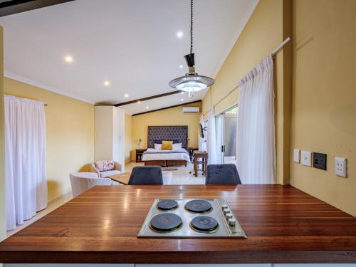 a living room with a table and a bedroom at Private Studio flatlet, Uncapped Wifi, Netflix,Full DSTV in Durban