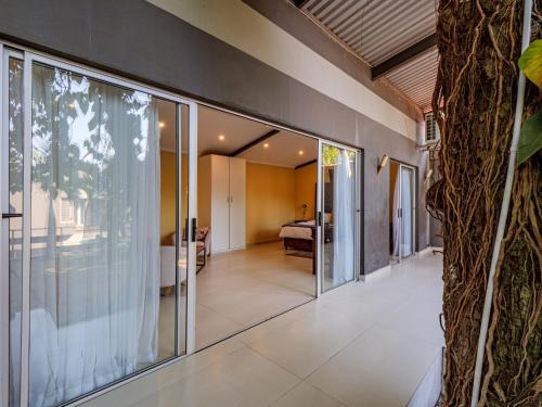 an open hallway with glass doors leading to a bedroom at Private Studio flatlet, Uncapped Wifi, Netflix,Full DSTV in Durban