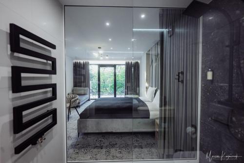 a bedroom with a bed and a glass door at Cristal in Ustka