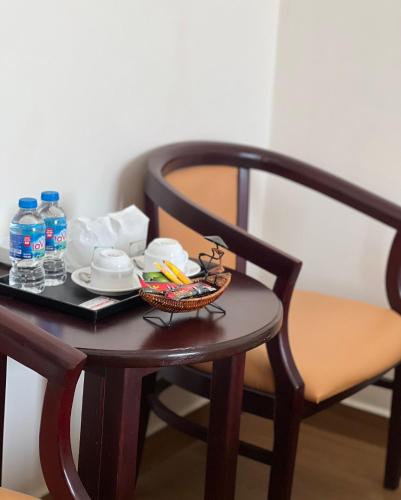 a table with a basket of food and water bottles at Chau Pho Hotel in Chau Doc