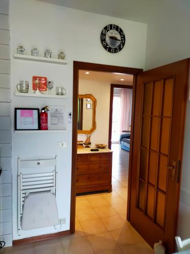 a bathroom with a sink and a clock on the wall at Appartamento Riviera Trilocale wifi e parcheggio privato in Ventimiglia
