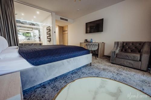 a bedroom with a bed and a chair and a window at Cristal in Ustka