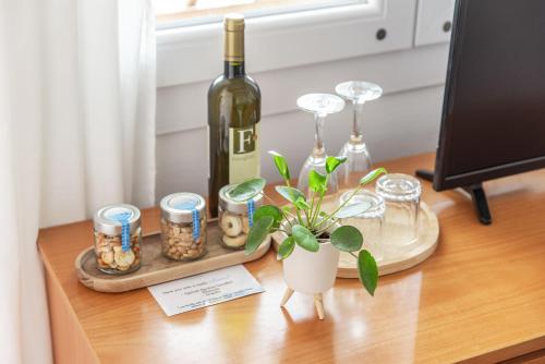 a table with a bottle of wine and a plant at A Casa di Elena in Polignano a Mare
