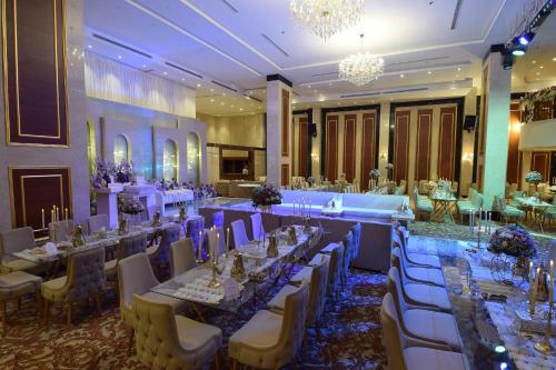 a banquet hall with long tables and chairs at Rosemond Al Hamra in Jeddah