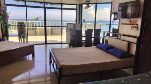 a bedroom with a bed and a view of the ocean at Glass Palace House Rental in San Vicente