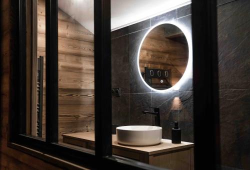 a bathroom with a sink and a mirror at Le refuge secret appartement cosy avec garage in Les Angles