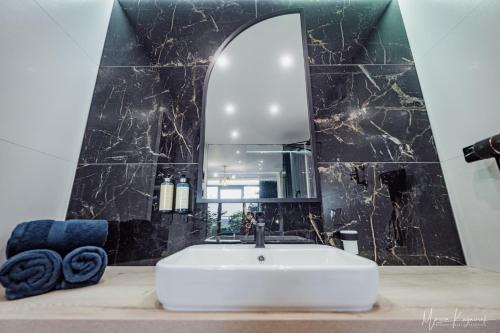 a bathroom with a white sink and a mirror at Cristal in Ustka