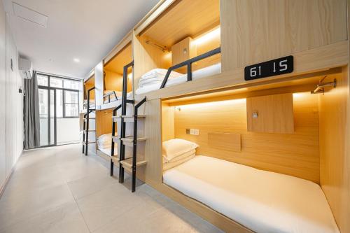 a dorm room with bunk beds in it at Denpa Inn - The Bund East Nanjing Road in Shanghai