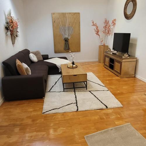 a living room with a couch and a coffee table at Ferienwohnungen Ahrweiler in Bad Neuenahr-Ahrweiler