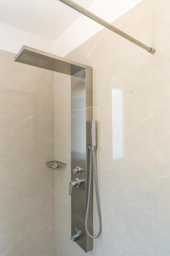 a shower with a glass door in a bathroom at Koumaries Villas in Lygia