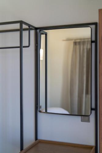 a mirror on a wall in a room at Koumaries Villas in Lygia