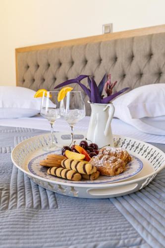 a plate of food on a table with wine glasses at Koumaries Villas in Lygia