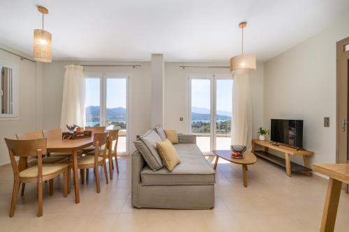 a living room with a couch and a table at Koumaries Villas in Lygia