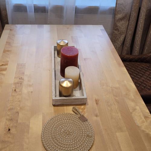 a wooden table with candles on top of it at Ferienwohnungen Ahrweiler in Bad Neuenahr-Ahrweiler