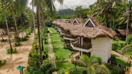 an aerial view of a resort with palm trees at Daluyon Beach and Mountain Resort in Sabang