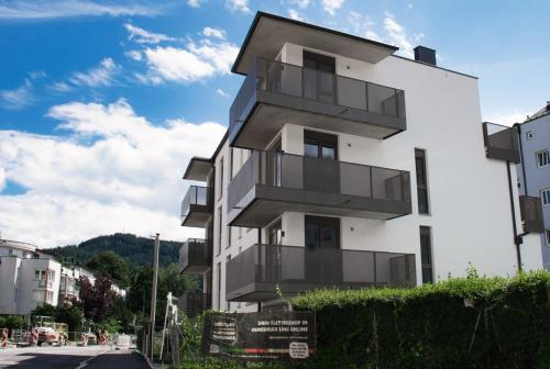 a building with balconies on the side of a street at myQuartier City Chalets in Innsbruck