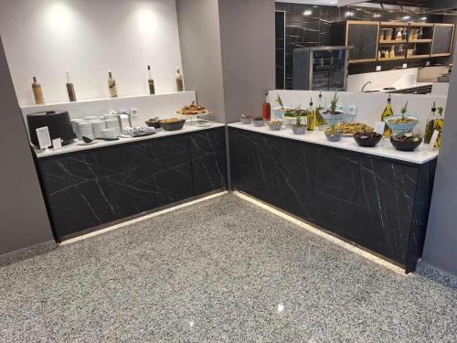 a kitchen with a counter with food on it at Kos Palace in Tigaki
