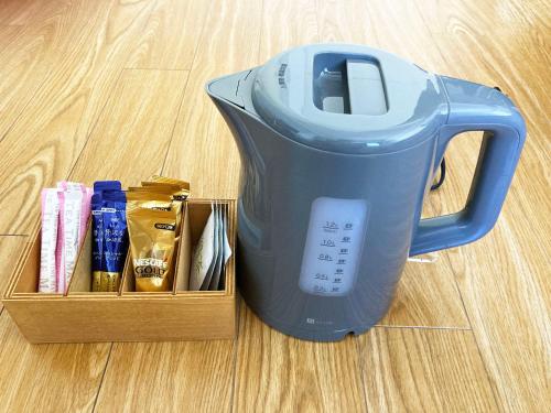 a blue blender sitting on the floor next to a box at Free bike and free WIFI 304 Take it easy in Kyoto
