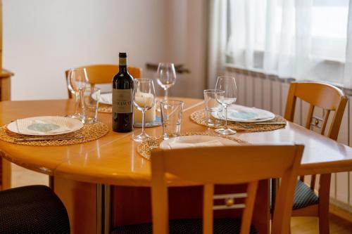 a wooden table with glasses and a bottle of wine at Fewo Naturliebe - keine Monteure in Dornhan