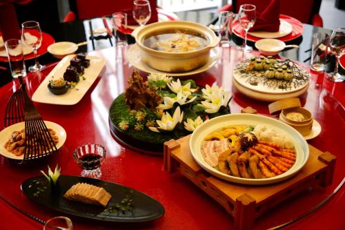 a table with plates of food on a red table at Crowne Plaza Shanghai Anting-Auto City - 15 Minutes drive to F1 in Jiading