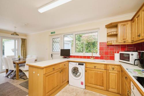 a kitchen with a washer and dryer at Beachfield in Bembridge