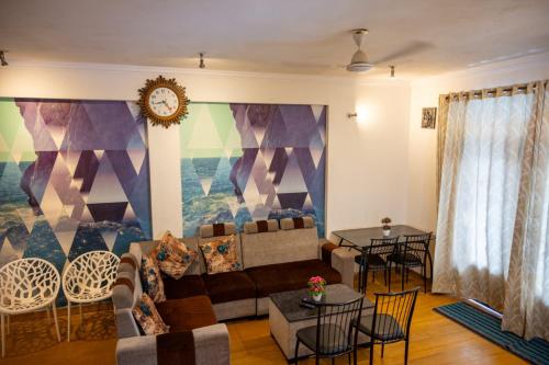 a living room with a couch and a table at Ronne's Candy Floss Blue Lagoon villa in Guirim