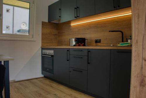 a kitchen with gray cabinets and a counter top at myQuartier City Chalets in Innsbruck