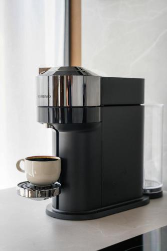a coffee maker sitting on a counter with a cup of coffee at The Riverside Mountain Lodge - 110sqm clam luxury - including bed linens, towels, in Idre