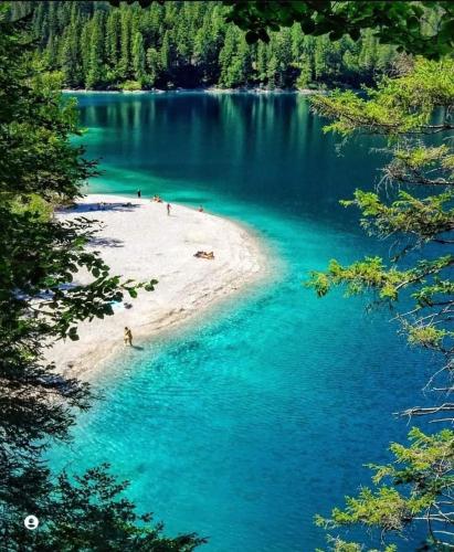 a beach in the middle of a body of water at Loft 69 - Green Relax in Cles