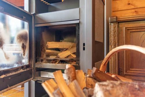 an open oven with a pile of wood in it at Ferienhaus Frankenglueck in Egloffstein