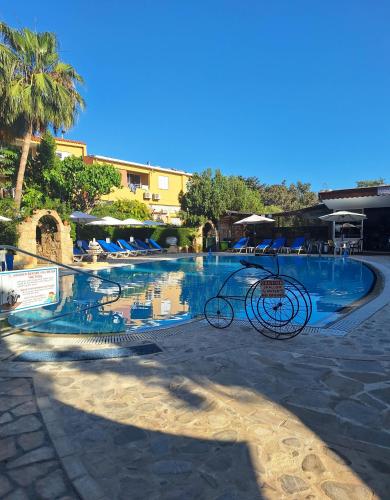 a bike parked in front of a swimming pool at Apollonia Hotel Apartments in Paphos