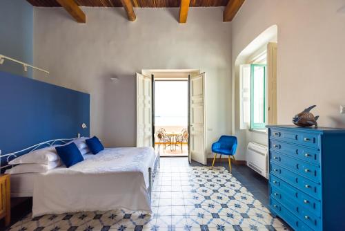 a bedroom with a blue bed and a blue dresser at Starhost - ANGOLO FELICE, charming seaview terrace in Vietri sul Mare