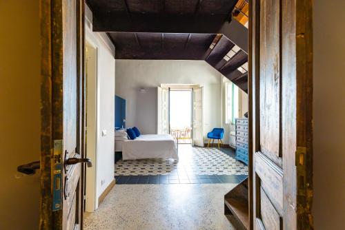 a bedroom with a bed and a room with a door at Starhost - ANGOLO FELICE, charming seaview terrace in Vietri sul Mare
