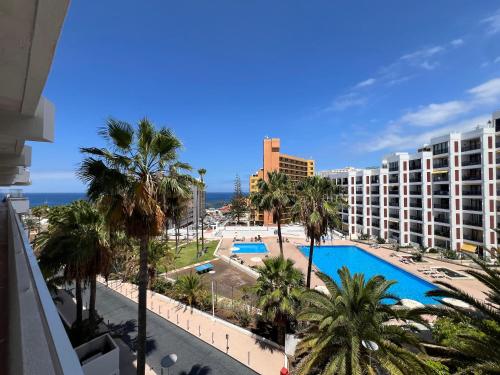 a view of a resort with a pool and palm trees at Tenerife Sea View Sun Beach Apartment 220 in Playa Fañabe