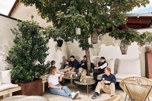 a group of people sitting on a patio at Lieperts Cafe Dinner Rooms Boutiqe-Zimmer Südsteiermark in Leutschach