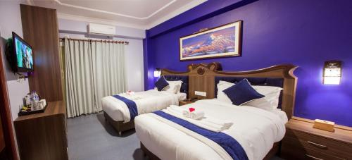 Una cama o camas en una habitación de Hotel Task International
