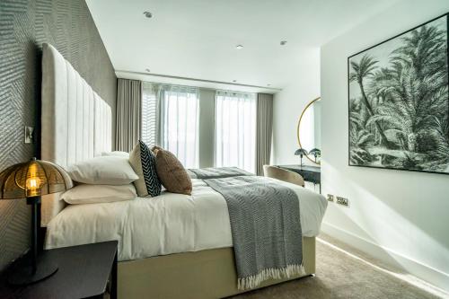 a bedroom with a bed and a large window at The Castle Suite @ Ryedale House in York