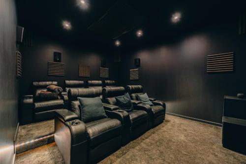 a theater room with a leather couch and speakers at The Nest Tenerife in Arona