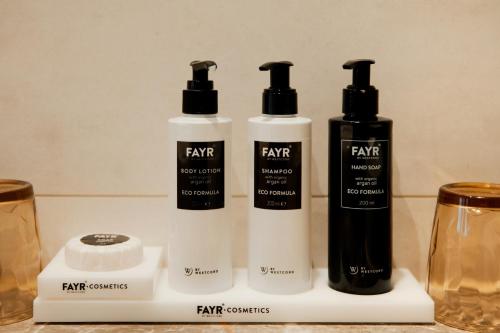 three bottles of hair products sitting on a counter at WestCord Hotel de Wadden in Oost-Vlieland