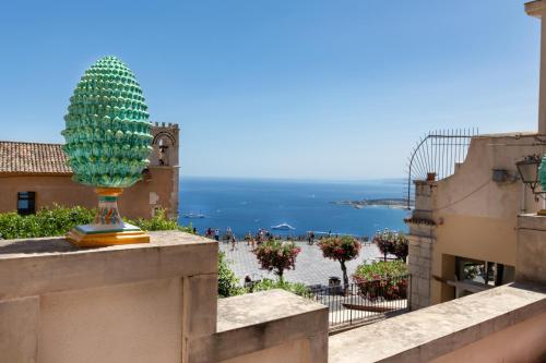a statue of a pineapple on the ledge of a building at Casa Acropoli Sea View Taormina Center in Taormina