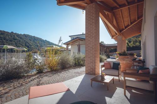 a patio with a table and chairs under a pavilion at Agriturismo La Pertica in Costermano sul Garda