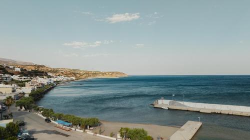 a view of a beach and the ocean at Southern Light Tsoutsouros in Tsoútsouros