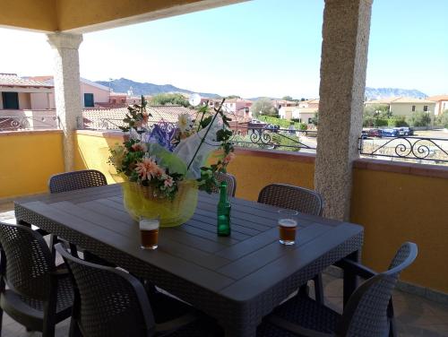 a black table with a vase of flowers on a balcony at Casa Marconi in San Teodoro