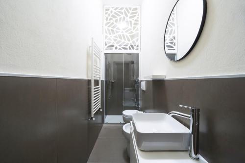 a bathroom with two toilets and a mirror at Loreto Prestige - Parking Free & Bulb Gym in Milan