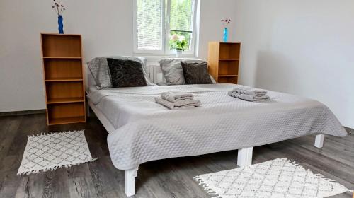 a bedroom with a bed with towels on it at Apartmán TINA in Rudolfov