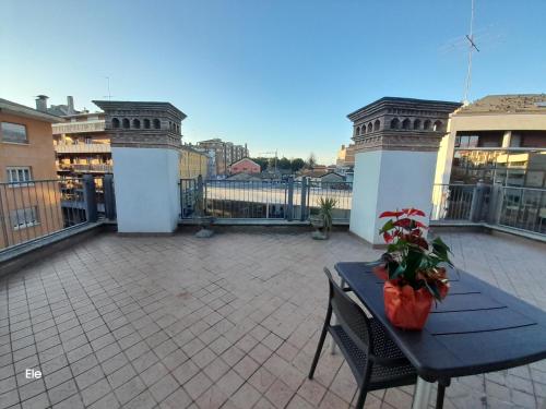 a patio with a table and chairs on a balcony at I Personaggi in Udine