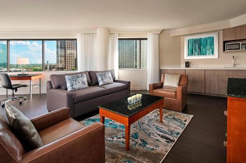 a living room with a couch and a table at Delta Hotels by Marriott Richmond Downtown in Richmond